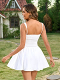Back view of a woman in a white fit and flare mini dress with a smocked back panel.