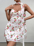 front view of a woman in a white cherry print dress with a scarf tied around her neck