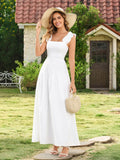 Woman in a white smocked bodice midi dress with ruffled straps and a wide-brimmed hat, holding a straw bag.