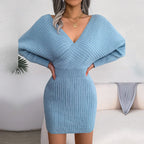 Woman posing in a blue long-sleeve knit dress
