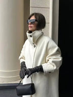 Full length view of a woman wearing a white wool blend maxi coat