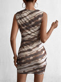 Back view of a woman in a sleeveless abstract print sheath dress.