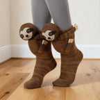 Brown knit ankle socks with attached sloth characters on legs