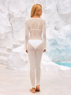 Back view of a woman in a white crochet knit maxi dress, showing the open knit pattern.