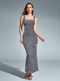 Full-length view of a woman wearing a sparkling silver sequined column gown with a square neckline and sleeveless straps, against a grey background.