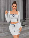 Back view of a woman in a white ribbed knit two-piece set, showing the detail of the top and skirt.