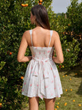 Rear view of a woman in a white floral print sleeveless mini dress with a square neckline, lace trim, and a tie back waist.