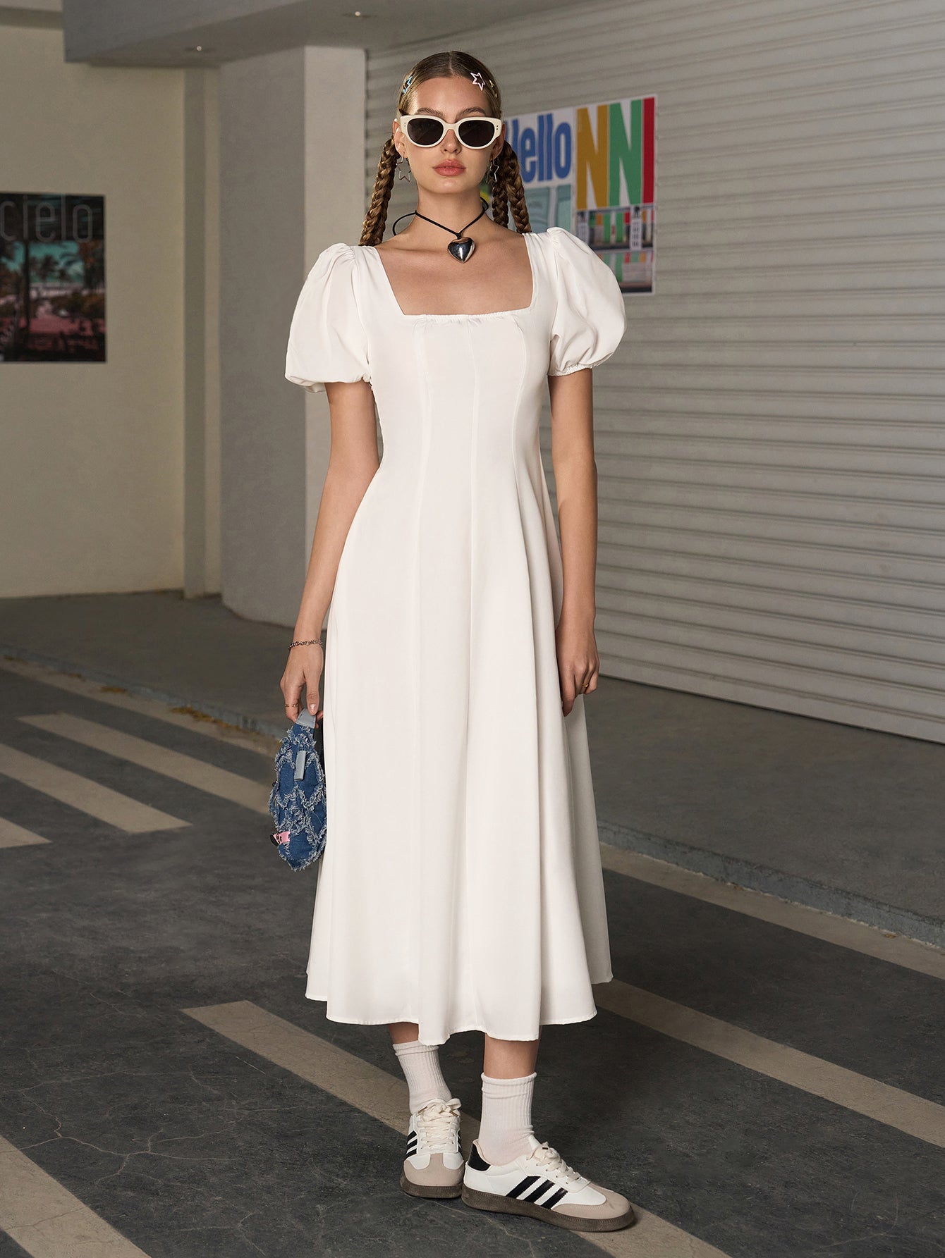 Woman wearing a white square neck puff sleeve midi dress.