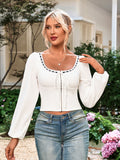 Front view of a woman in a white lace-trimmed square neck top, showing the smocked bodice and lace-up detail.