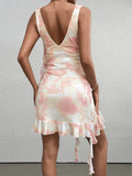 Back view of a woman in a pink and white tie-dye satin mini dress with ruffle trim.
