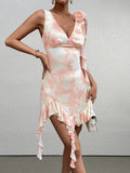 Woman in a pink and white tie-dye satin mini dress with ruffle trim and floral shoulder accent, holding a white handbag.