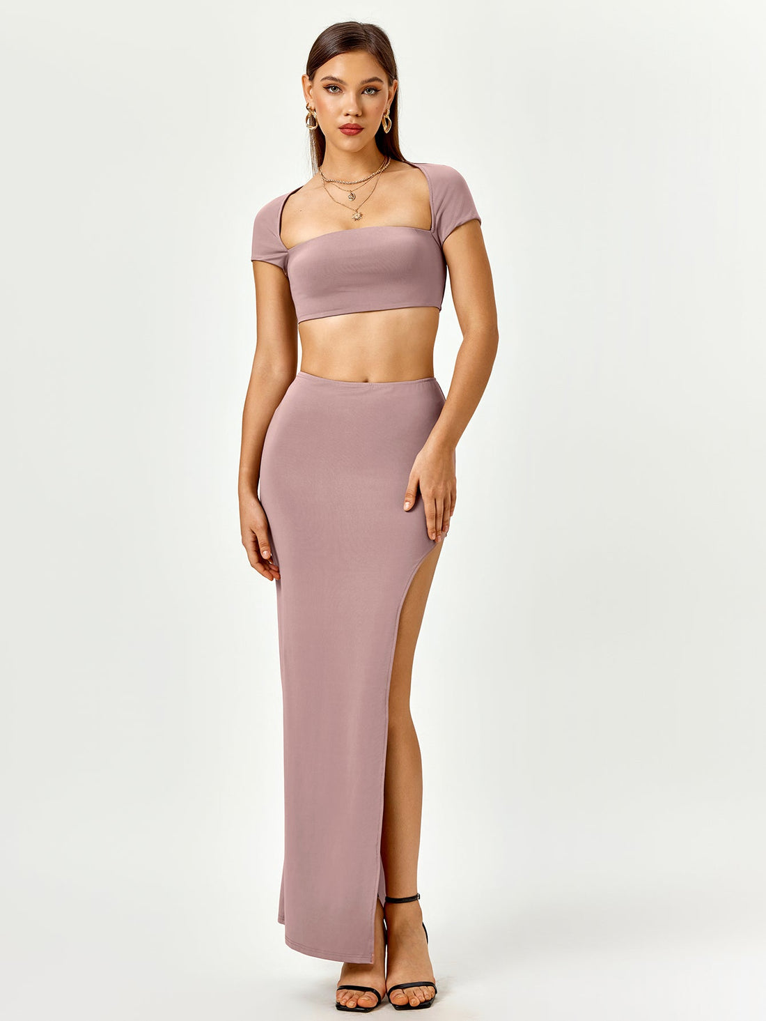 Woman wearing a mauve two-piece set with a square neck cropped top and a high slit maxi skirt.
