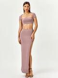 Woman wearing a mauve two-piece set with a square neck cropped top and a high slit maxi skirt.