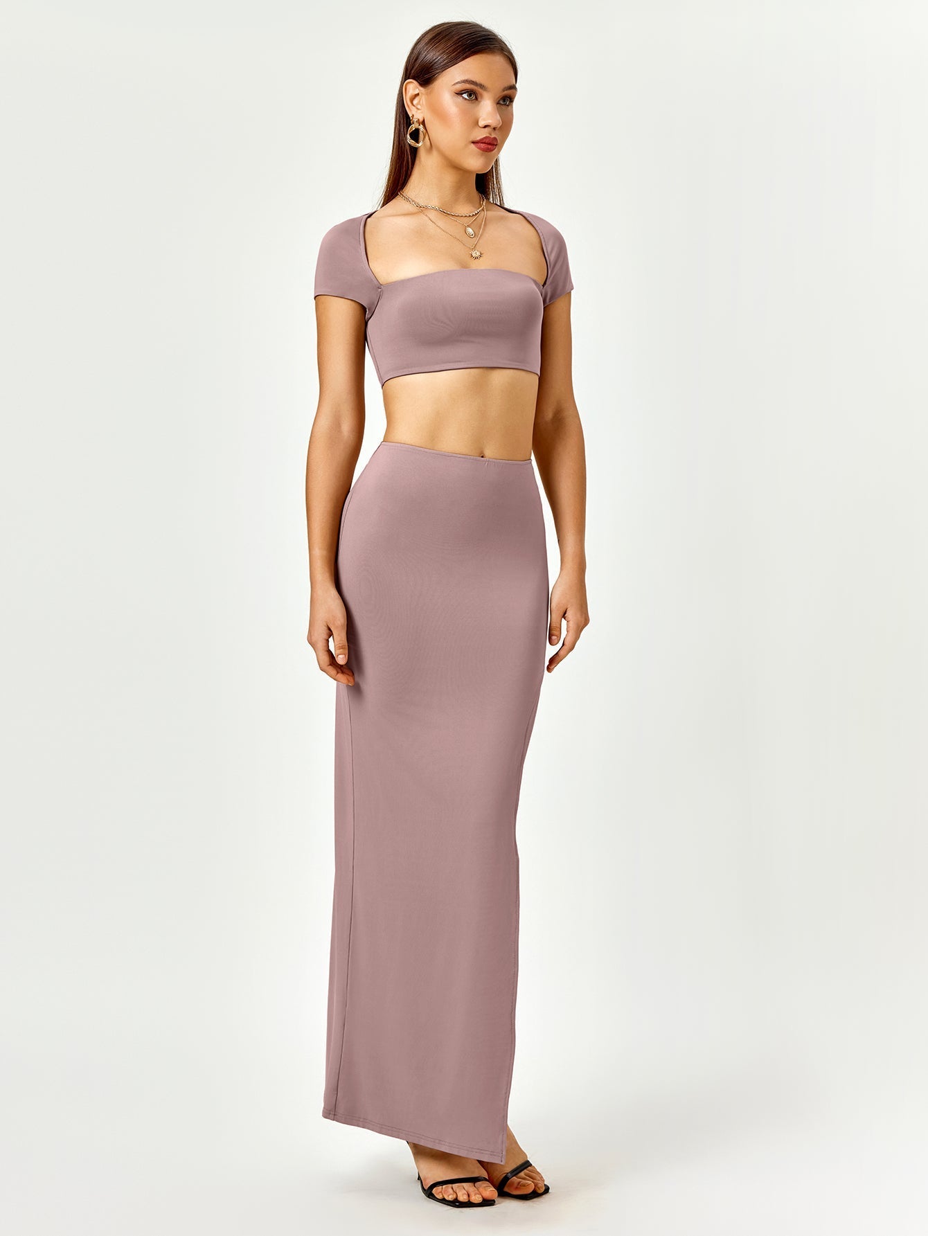 Front view of a woman in a mauve square neck cropped top and high slit maxi skirt.