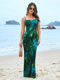 Woman wearing a green and blue tie-dye spaghetti strap mermaid maxi dress on the beach