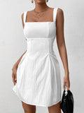 Model posing in a white textured dress with a square neckline and flared skirt.