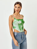 Side view of a woman in a green tie-dye print cropped corset top with adjustable spaghetti straps and a square neckline.