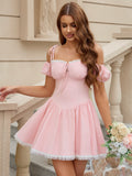 Woman posing in a pink party dress with off-the-shoulder sleeves and a flared skirt.