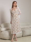 Full body shot of a woman in a white lace midi dress with bell sleeves.