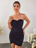 Woman posing in a black strapless sparkle mini dress