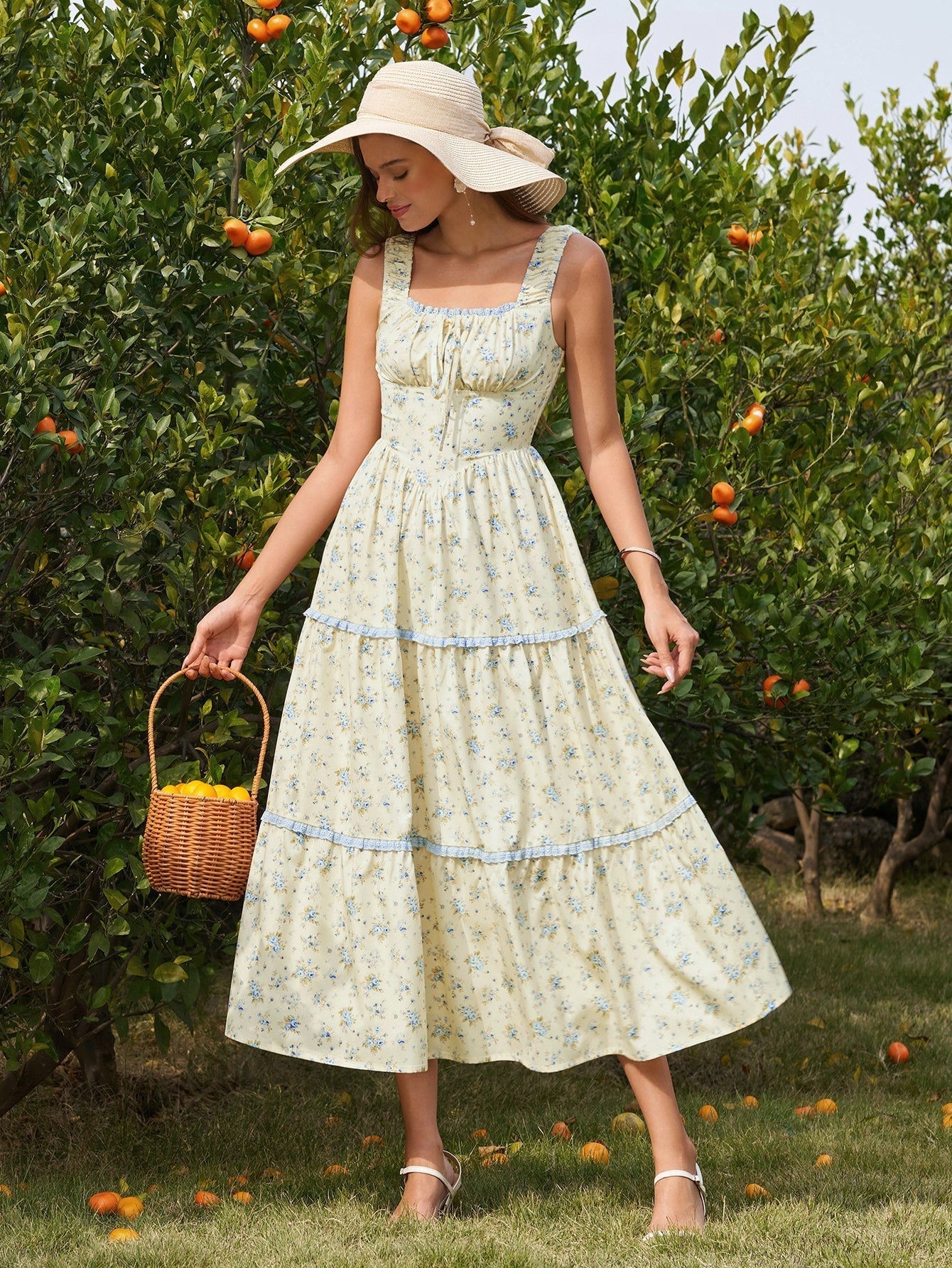 Close-up of the smocked bodice and tie front detail on a yellow floral print midi dress.