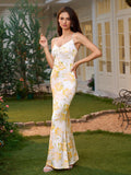 Front view of a woman in a long floral print slip dress with spaghetti straps, styled with earrings and a bracelet.
