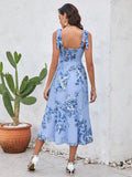 Back view of a woman in a blue floral print midi dress with smocked back.