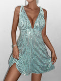 Detail shot of a woman's arm and hand on a light blue sequined mini dress.