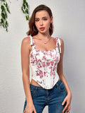 Front view of a woman in a white and red toile print corset top with tie straps, paired with blue jeans