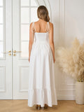 Back view of a woman in a white maxi dress with a smocked back and tiered ruffle hem.
