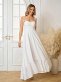 Woman twirling in a white flowing maxi dress with tie straps.