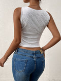 Back view of a woman in a white lace crop top and blue denim jeans.