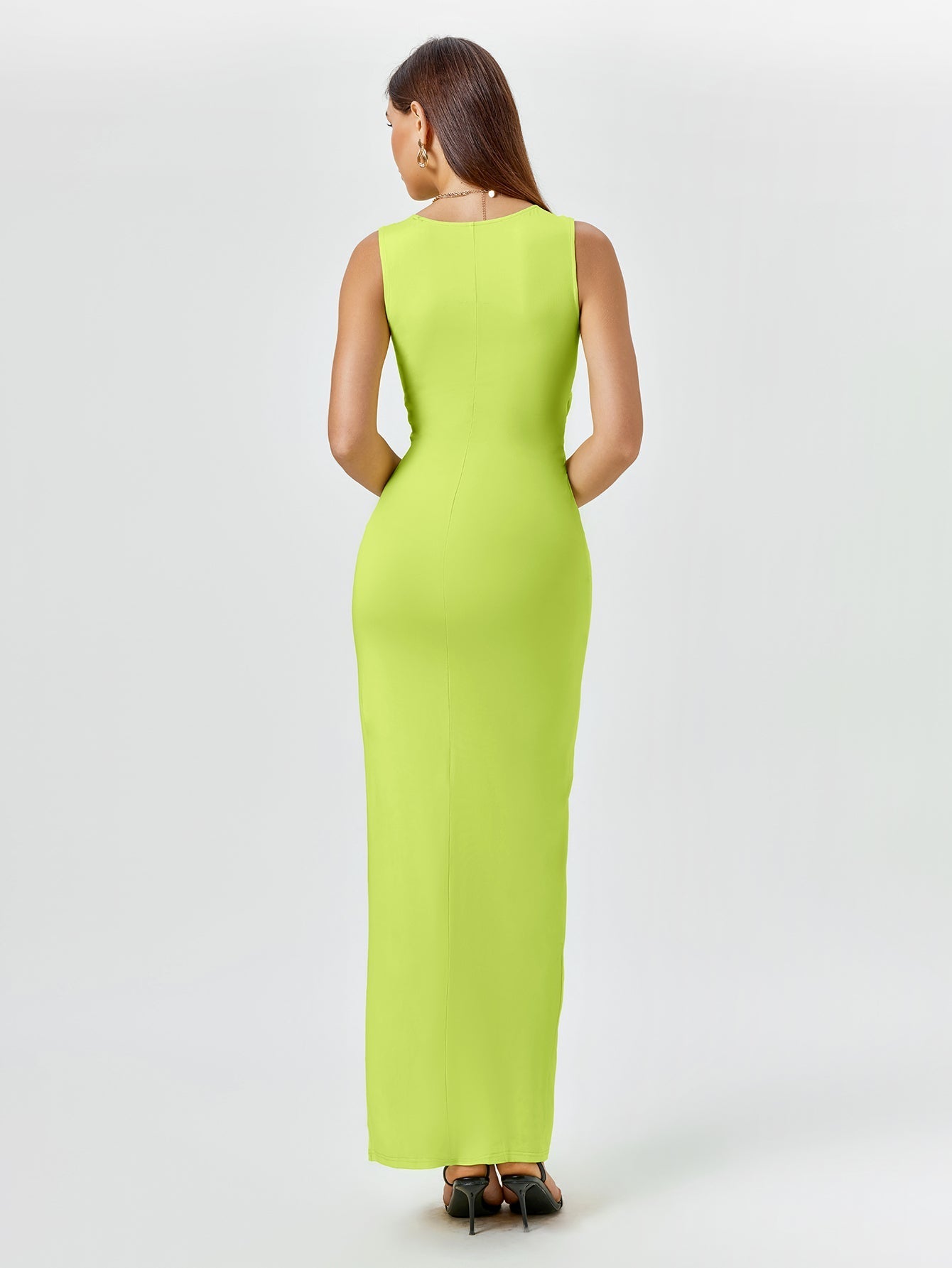 Back view of a woman in a sleeveless lime green maxi dress.