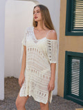 Woman wearing a white knit beach tunic, showing off the open knit detail