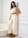 Woman posing in a cream-colored loungewear set, showing the fit of the pants.
