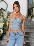 Fashion model showcasing a blue lace corset top with a structured bodice and delicate lace trim.