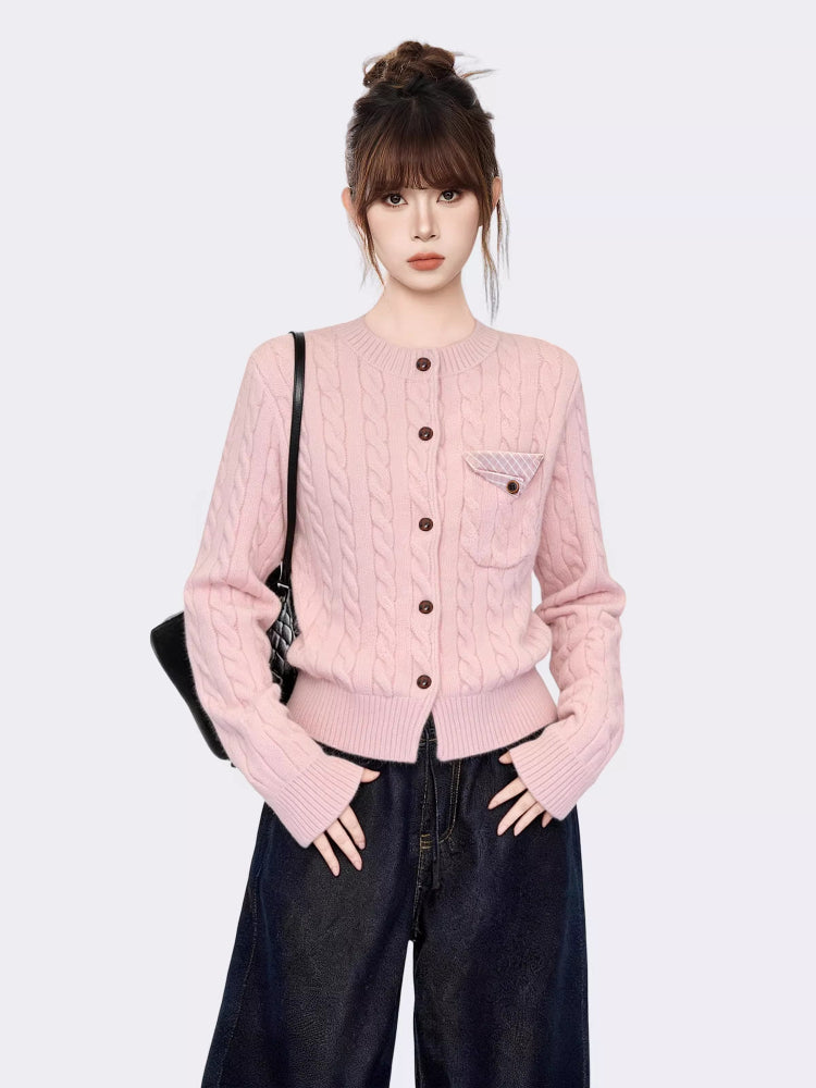 Woman wearing a pink cable knit cardigan with a chest pocket
