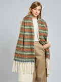 Close-up of a woman's outfit featuring a multi-colored striped scarf with tassels.