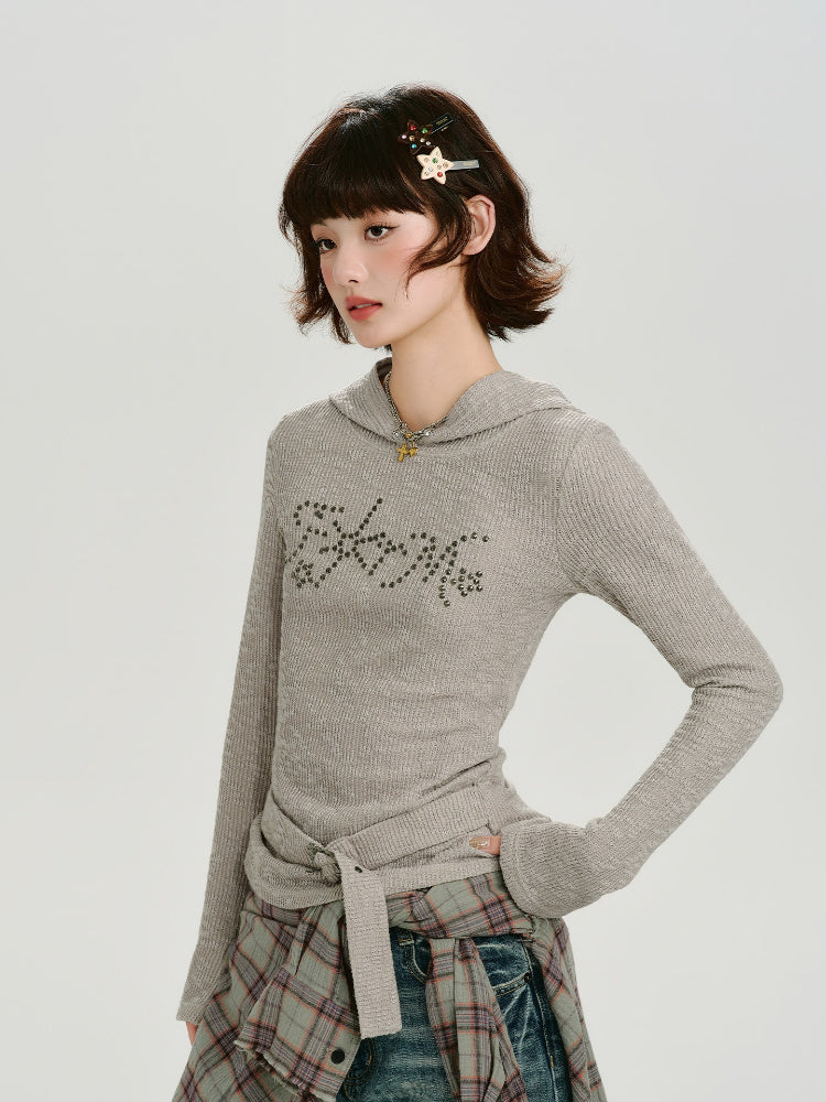 Side view of a model wearing a grey ribbed knit hooded long sleeve top with a belted waist.