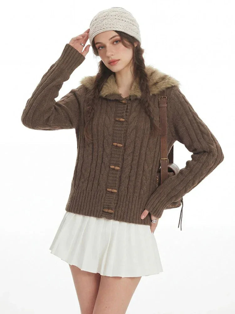 Close-up of the brown cable knit cardigan with wooden button details.