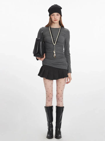 Model wearing heathered gray long sleeve top with ruched detailing