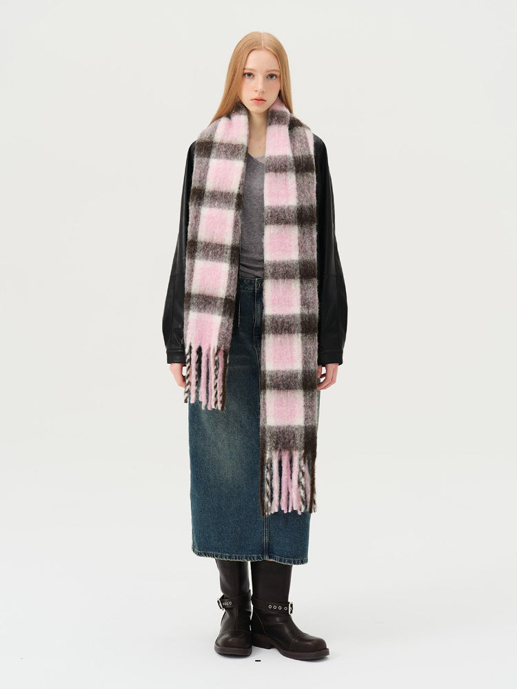 Woman wearing a pink and brown plaid scarf