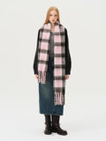 Woman wearing a pink and brown plaid scarf