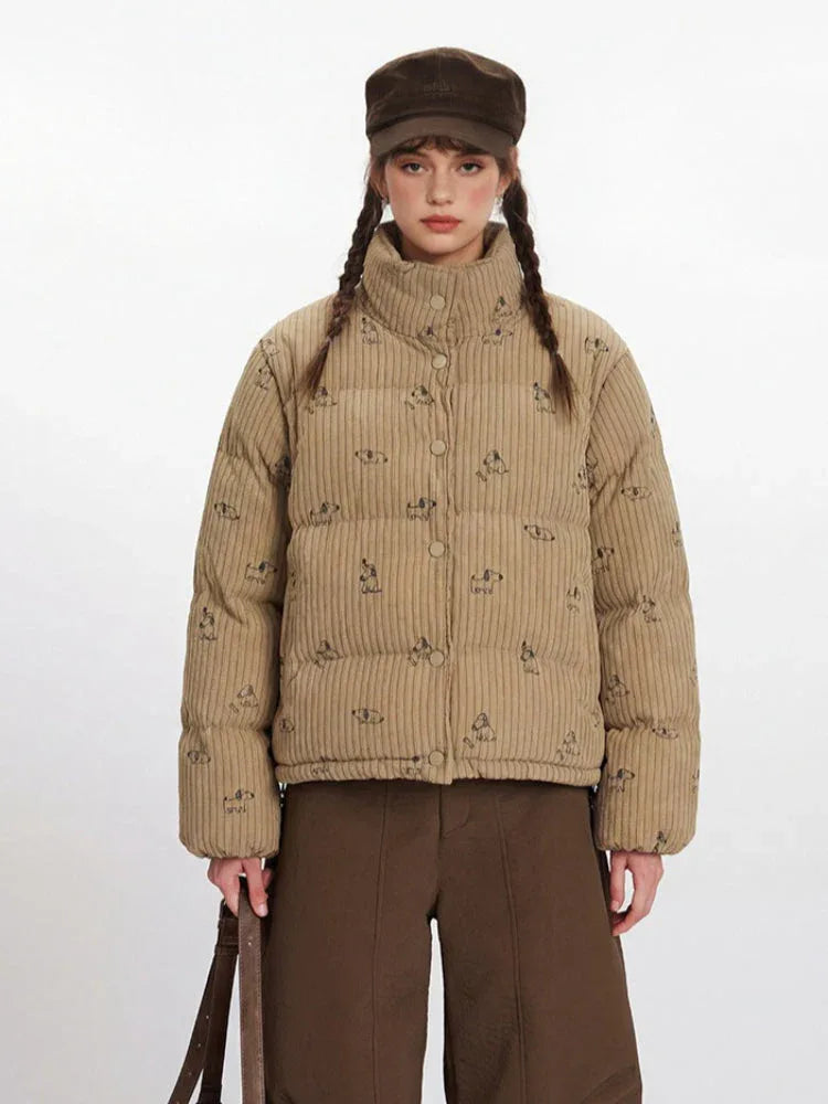 Close-up front view of a tan corduroy puffer jacket with a dog print.