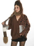 Close-up of a woman wearing a brown knit cardigan with a V-neck and leopard print detailing.