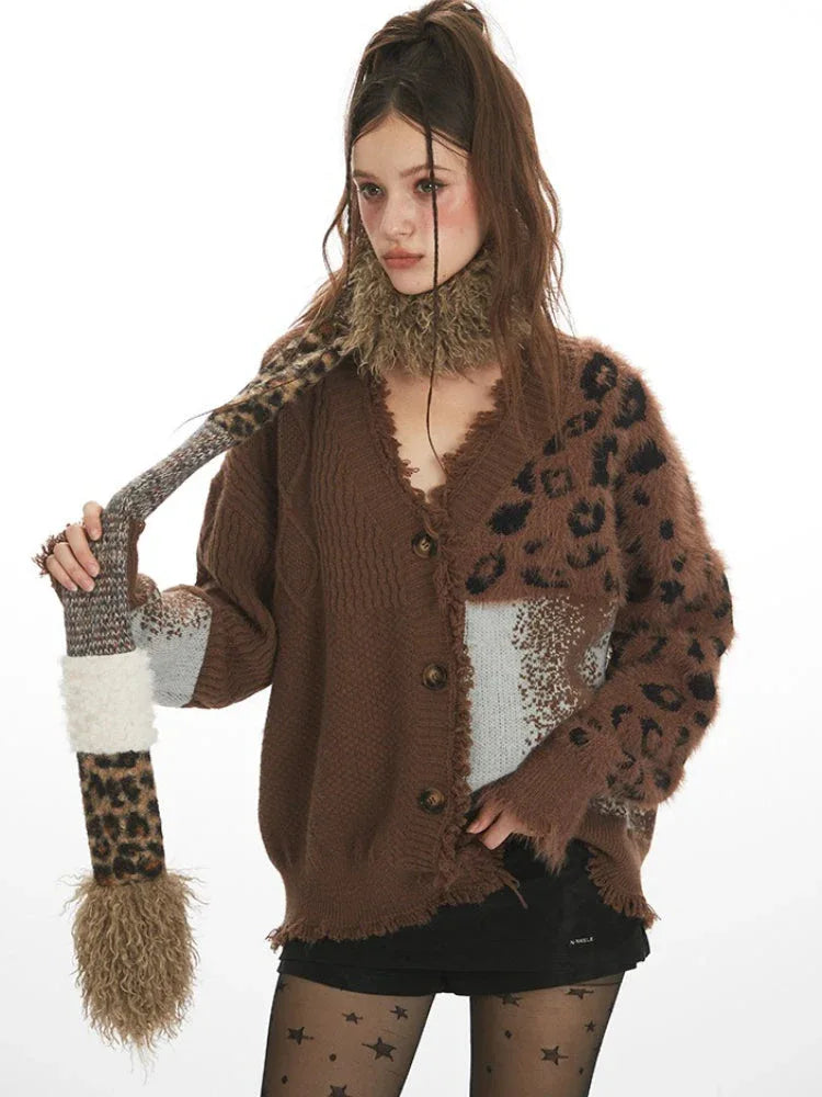 Close-up of a woman wearing a brown knit cardigan with a V-neck and leopard print detailing.