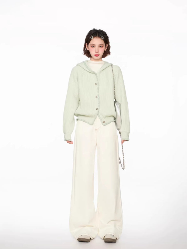 Front view of a woman showcasing a light green hooded knit cardigan with button closure.