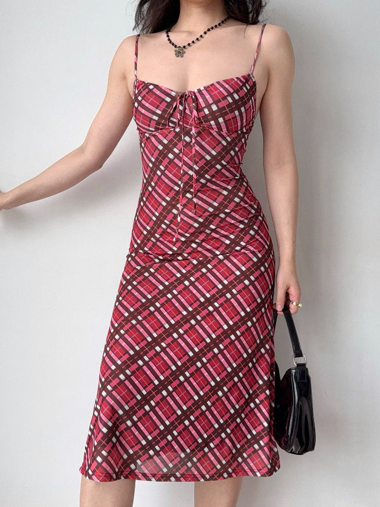 side profile of a woman in a red and pink plaid mesh midi dress