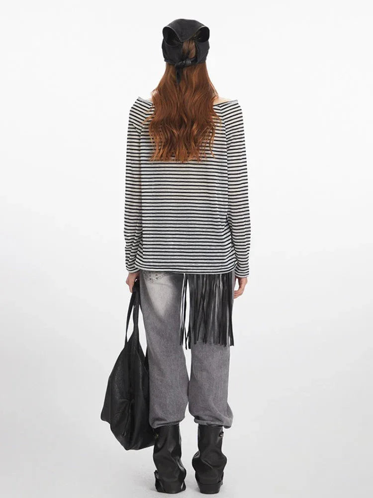 back view of a woman wearing a black and white striped long-sleeve shirt