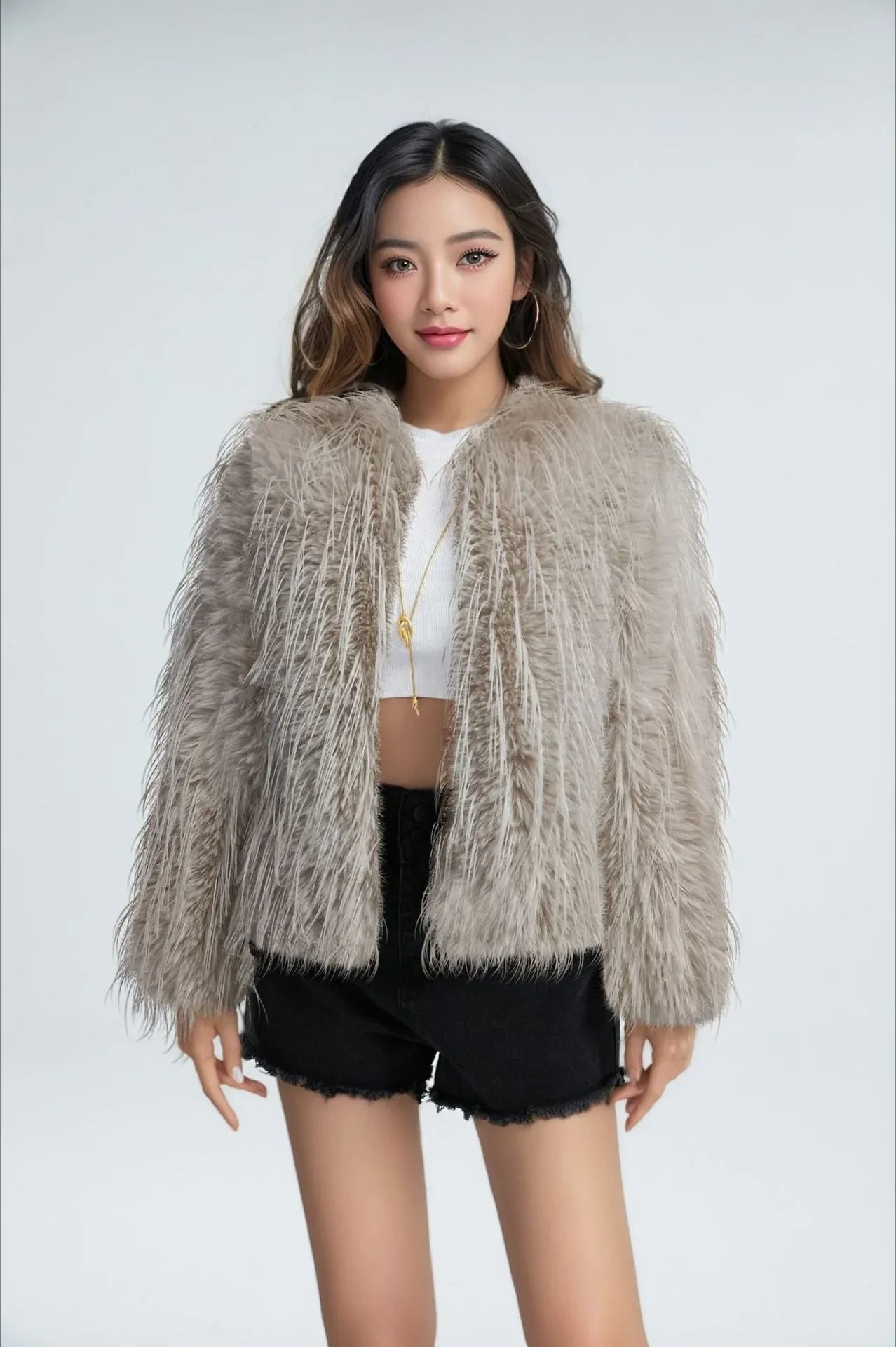 Woman wearing a grey shaggy faux feather cropped jacket